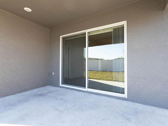 The gathering room opens to outdoor living on your covered lanai - New home for sale in Zephyrhills,