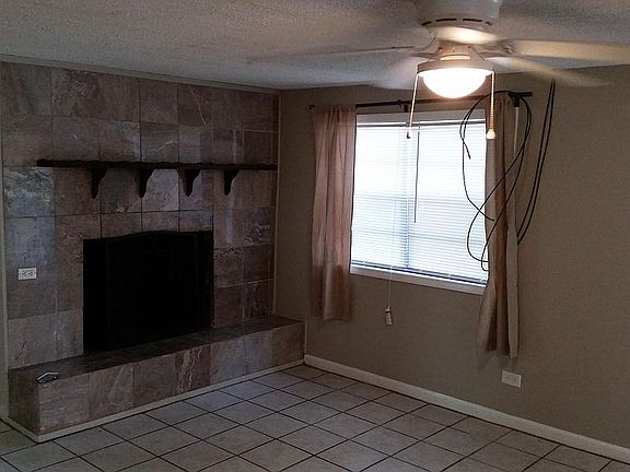 Den with wood burning fireplace