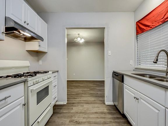 Other view of kitchen. Granite countertops. Large sink with garbage disposal.