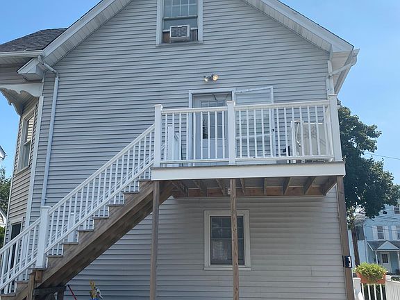 Back of house with deck