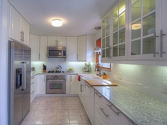 The chefs kitchen features 42 inch cabinetry, Quartz counter tops, soft close drawers, classic white back splash, and stainless 