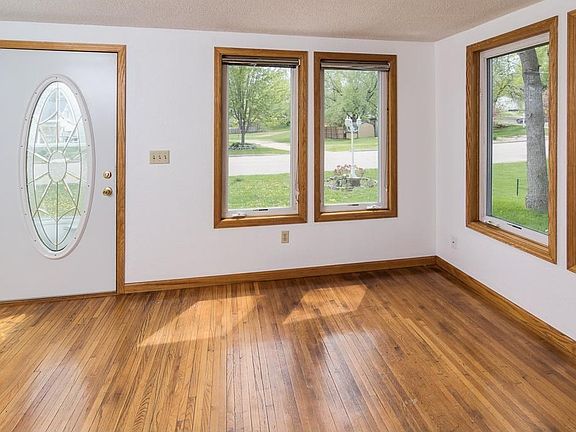 Sun porch entry has hardwood floors and lots of light.