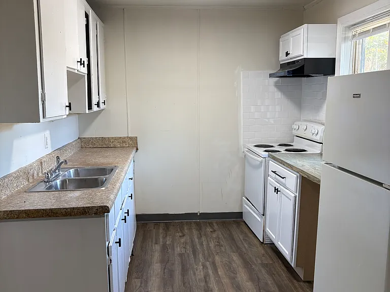 Kitchen with oven and refrigerator