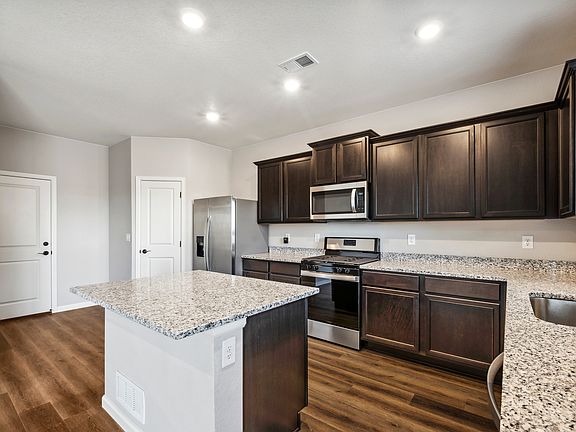 You will love the included stainless appliances and features like the espresso cabinets.