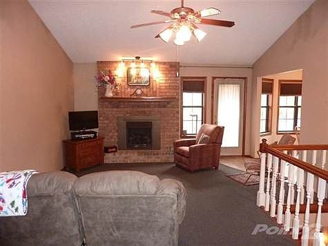 Looking from the entry to the cozy living room with door to the deck and spacious dining area to the