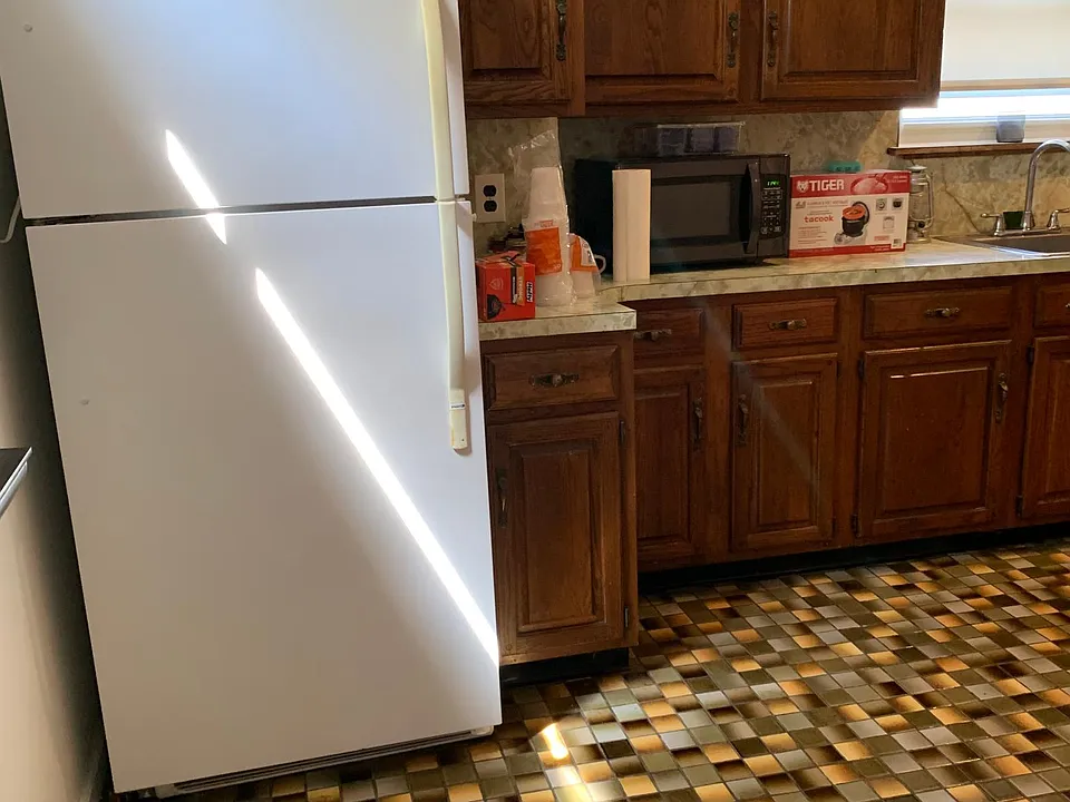 Wood cabinets; tile floor. Several windows bring in abundant sunlight