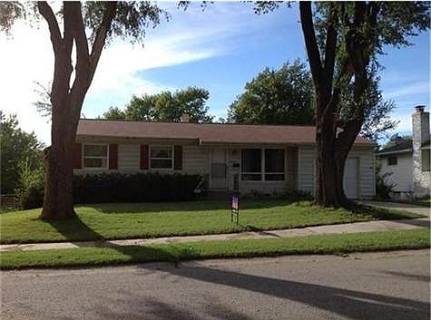 Charming home on quiet street with sidewalks and mature trees.
