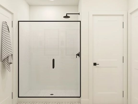 Glass shower enclosure with matte black finishes