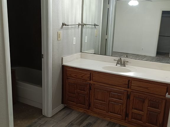 Toilet and tub have separate area.