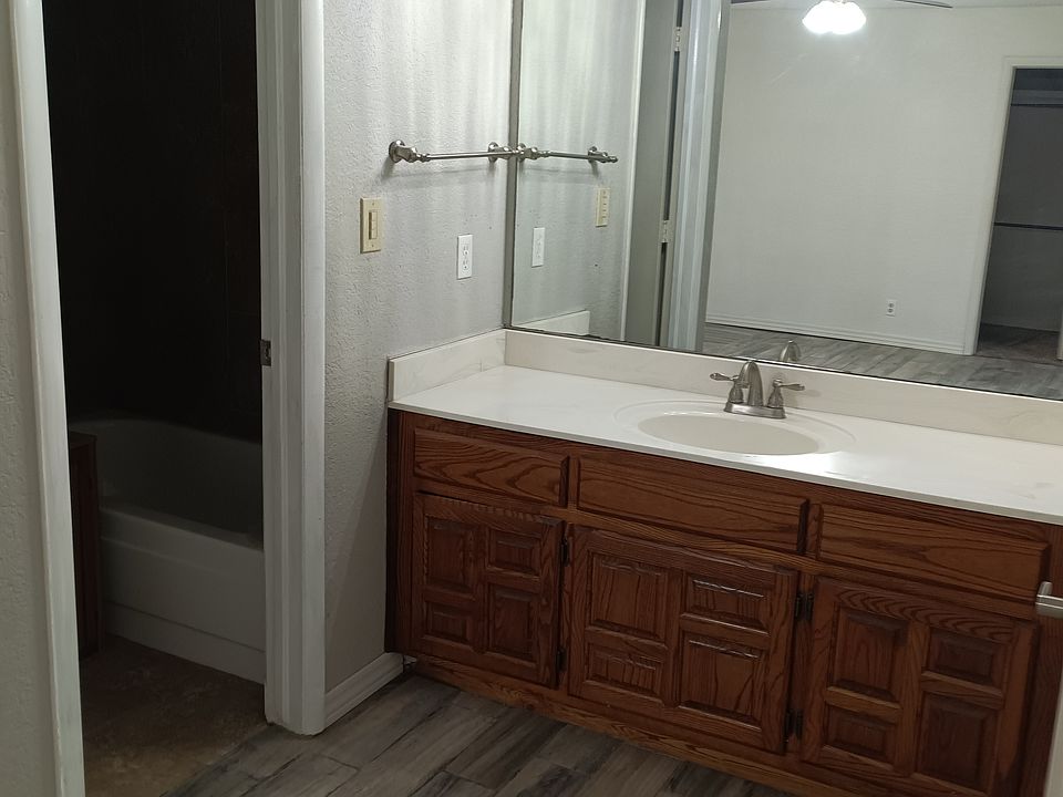 Toilet and tub have separate area.