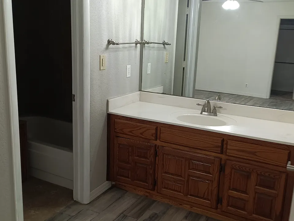 Toilet and tub have separate area.
