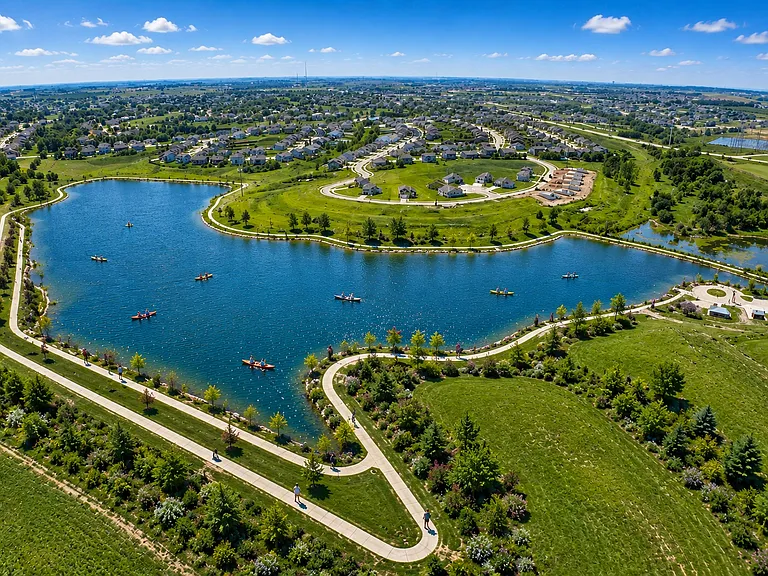AI rendering of the newly completed community recreation lake as it continues filling with rainwater and runoff. Trails and lake infrastructure are complete. Home backs directly to the green space and trail area near the upper left side of the lake.