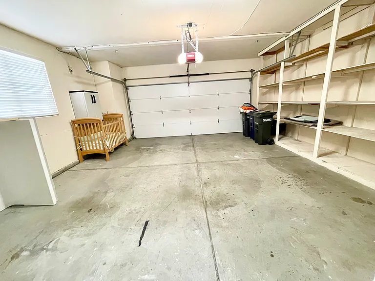 Attached two car garage with storage shelves