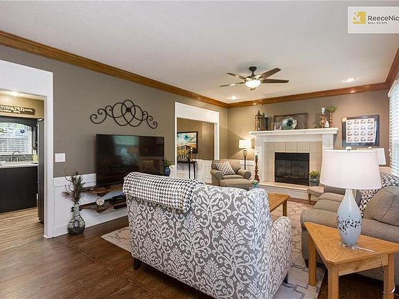 Main floor family room with fireplace and ceiling fan is a great space to relax and watch TV.