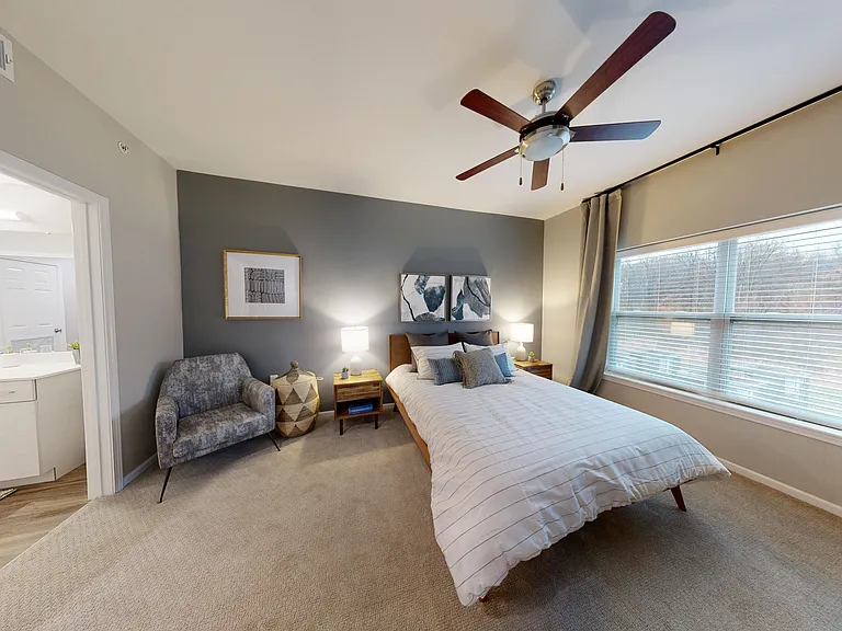 The Dogwood floor plan's one bedroom provides ample space, a large window, ceiling fan, and direct access to the bathroom. The Dogwood floor plan's one bedroom provides ample space, a large window, ceiling fan, and direct access to the bathroom.