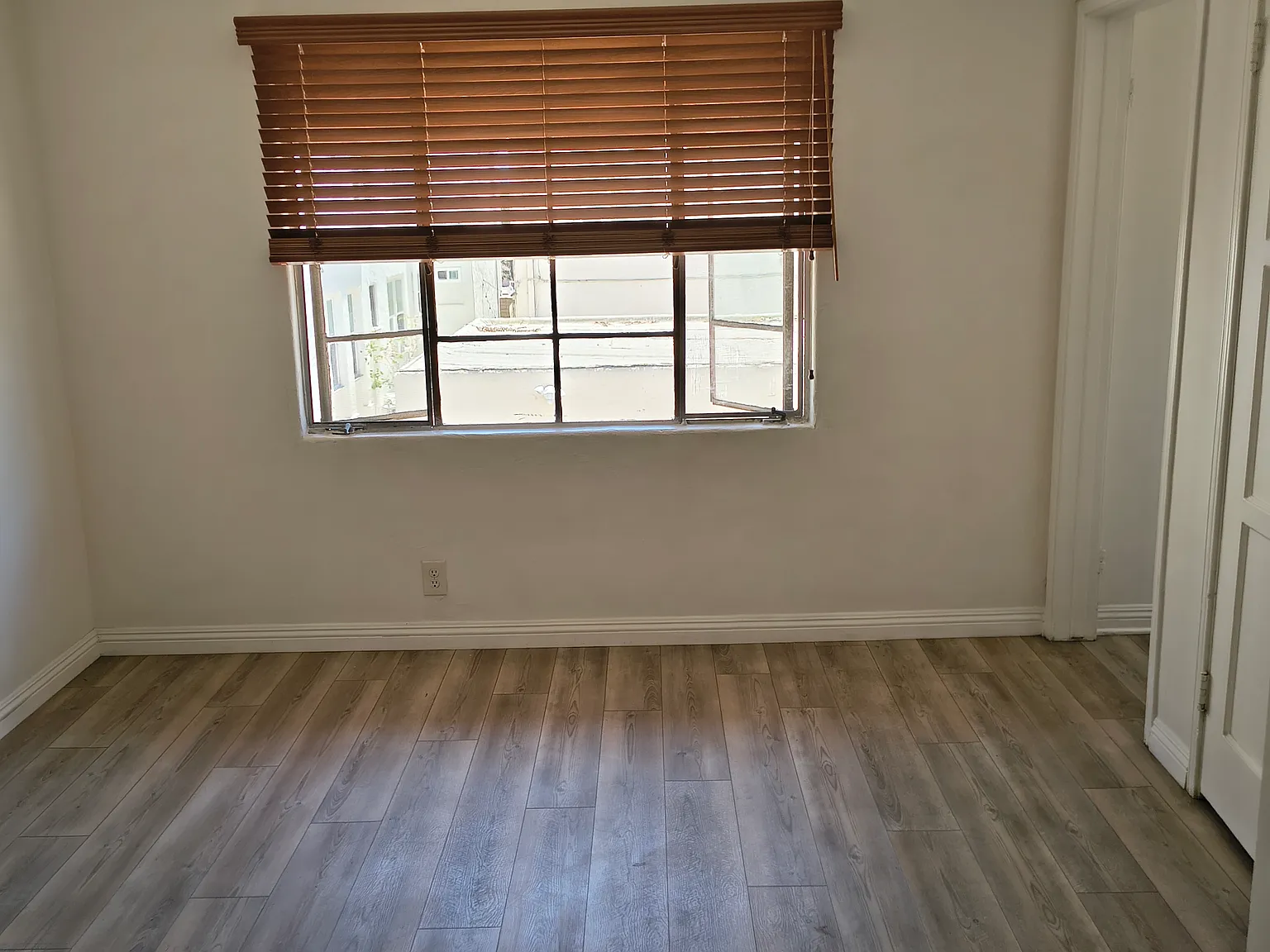 a living room can look uninviting and small, so the next picture shows the room as furnished by a prior tenant.