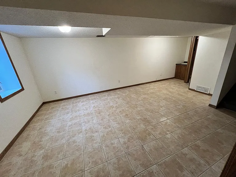 Lower family room / play room with sink/bar area.