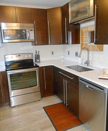 Beautiful wood cabinets plus stainless and glass display cabinet.