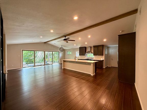 Open living. Large living room with kitchen and dining. Large sliding glass doors to the patio overlooking the creek.