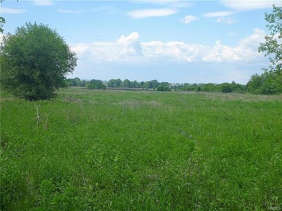 View looking out towards the land. Fence on the right belongs to the neighboring property and is on other side of the irrigation