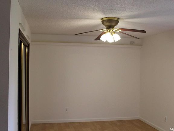 Bedroom has been painted, mirrored closet doors and ceiling fan.