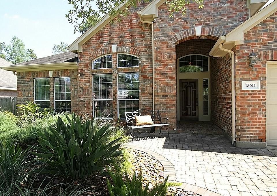 Custom pavestone walk way leads to the brick front porch.