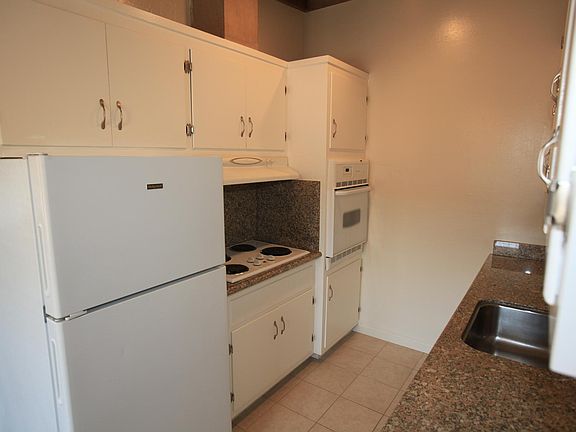Freshly painted cabinets an new countertops with high ceilings