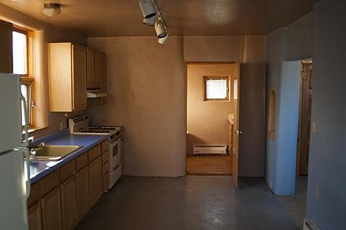Kitchen into bathroom. Main room on right.