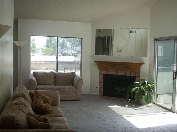 LIVING ROOM W/FIREPLACE AND POOL VIEW