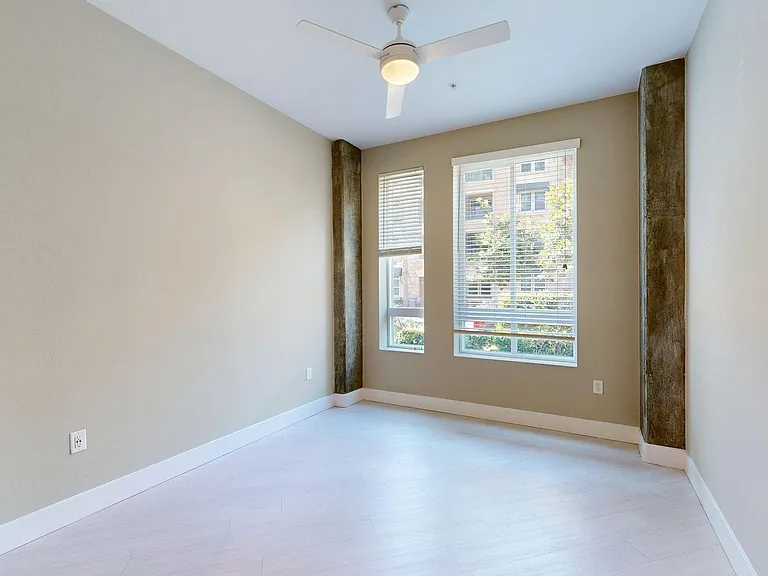 Spacious apartment Bedroom with Wood-Style Flooring.