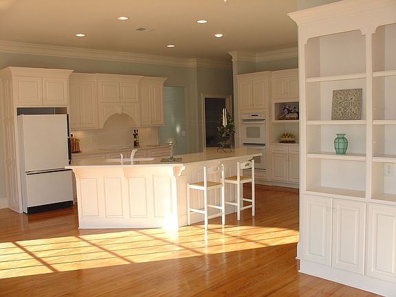 Kitchen viewed from den with entertainment center.