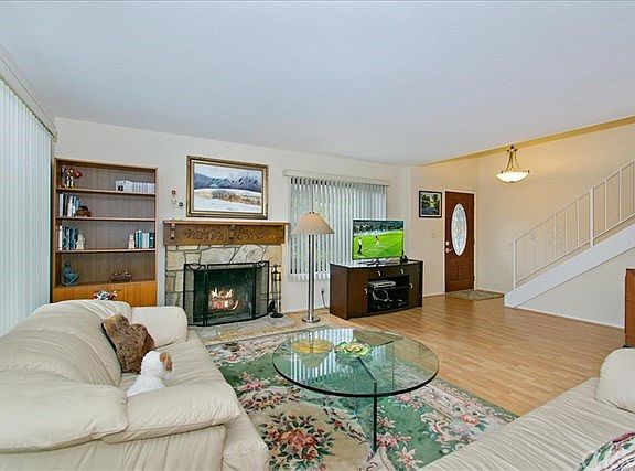 Living room with stairway to 3 bedrooms