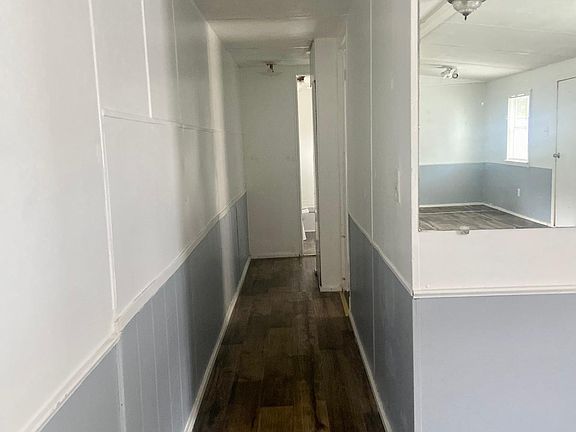 Hallway to additional bedrooms and guest bathroom.