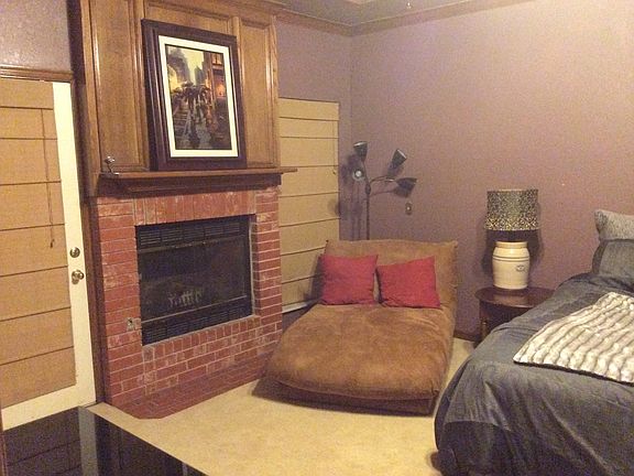 fireplace in large bedroom, and door to large deck