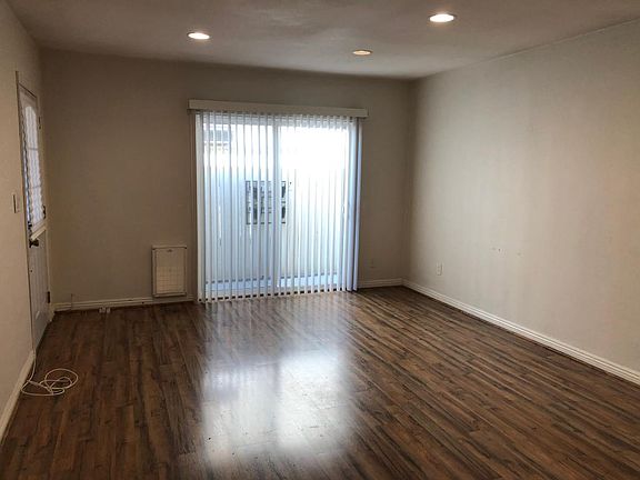 living room with slider to back patio and garage access