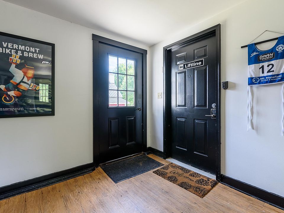 Door with windows is the door to general building entry way; solid black doo is door to enter apartment