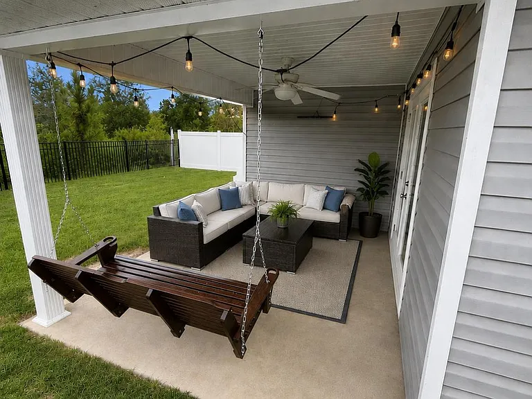 Covered Patio with fenced in backyard.