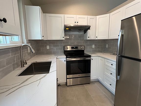 Fully remodeled kitchen with stainless steel appliances & sleek finishes