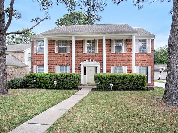 Lovely curb appeal with lush landscaping and beautiful mature trees.