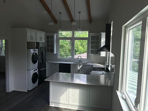 View of kitchen with counter top open to living room