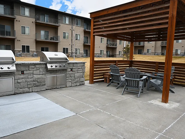 Community grills next to firepit at The Sterling Kearney.