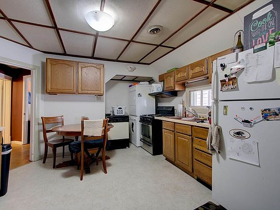Kitchen (viewed from the entry door). Washer and dryer in the corner.