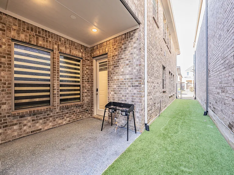 outdoor side yard turfed for cleanliness and comfort