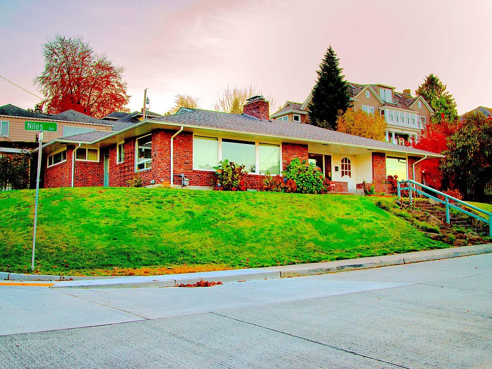 Large corner lot with charming brick exterior, new windows and new roof