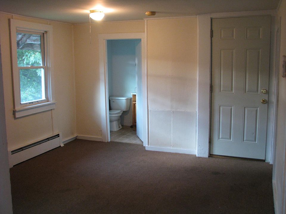 Looking from medium bedroom into living room, bathroom & entrance.