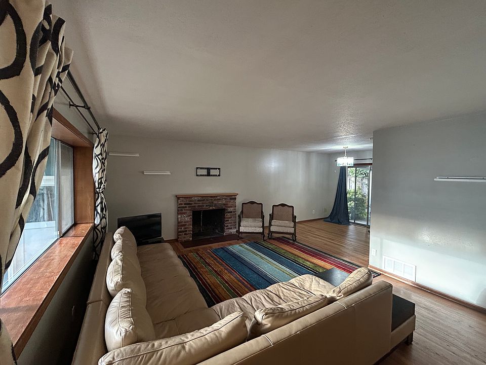Bright, spacious living and dining area. Hard wood floors and fireplace make for a cozy space.