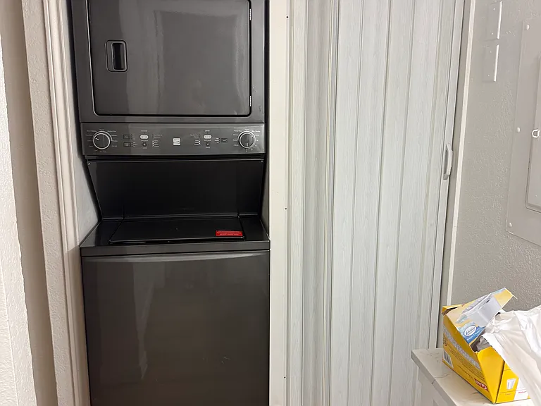 Washer and dryer with water heater closet.