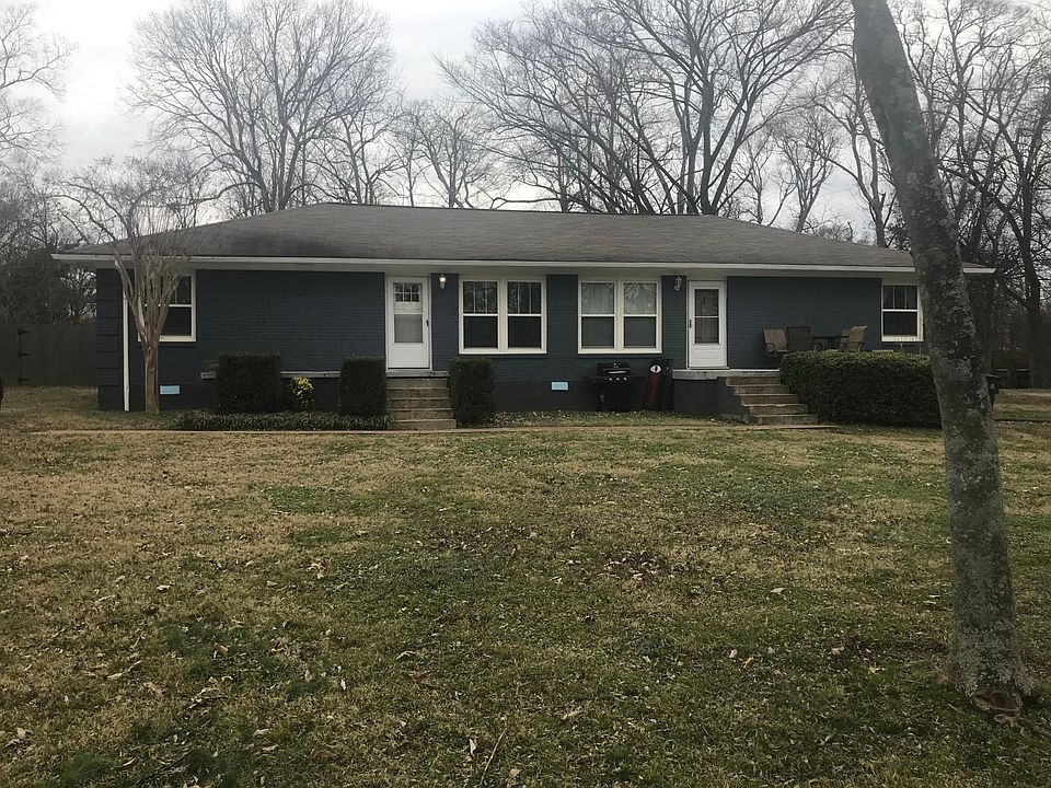 Front of house and entrance. Unit on left
