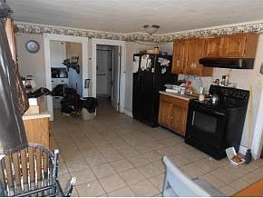 Kitchen, leading into the laundry room and first floor bathroom.