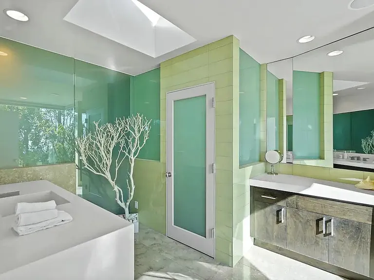 Experience the serene ambiance of the ensuite bathroom in the primary bedroom, with a skylight providing natural light.